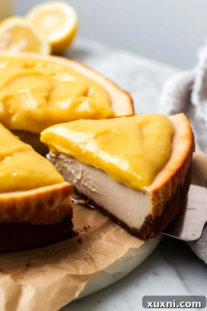 Sliced vegan lemon cheesecake on a plate, showing its creamy texture and golden crust.