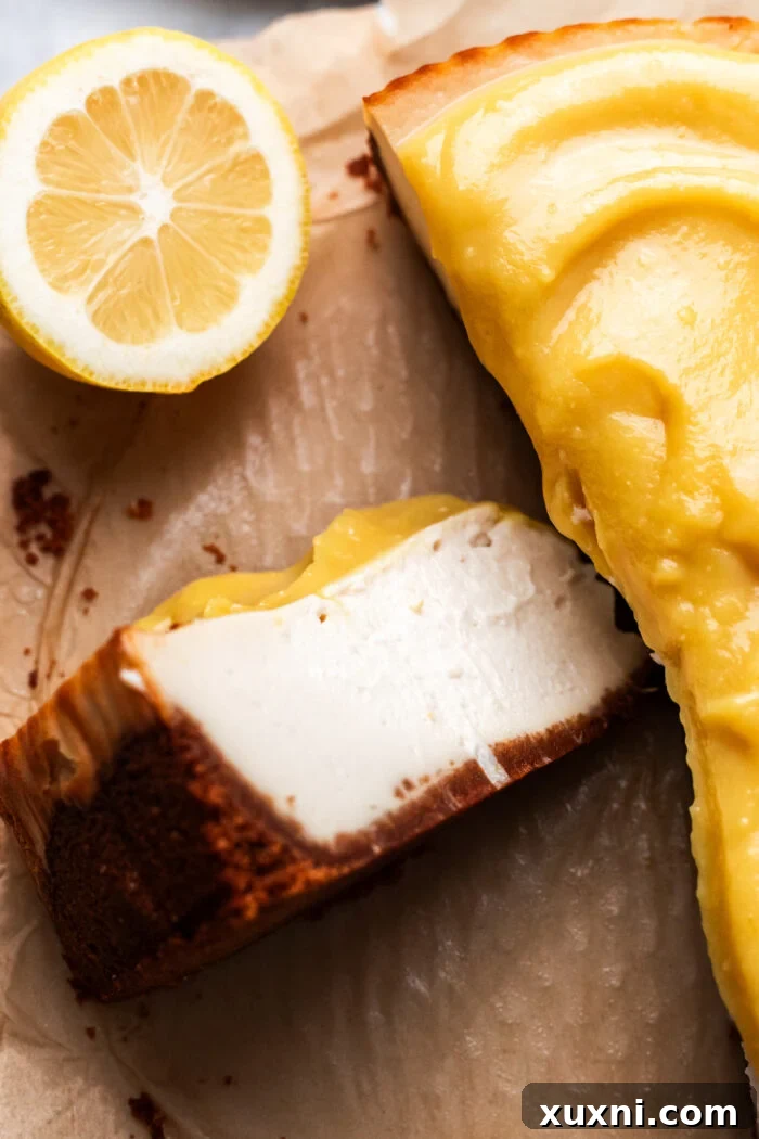 Close-up of a perfectly sliced vegan lemon cheesecake, showcasing its smooth, creamy filling and crunchy graham cracker base.