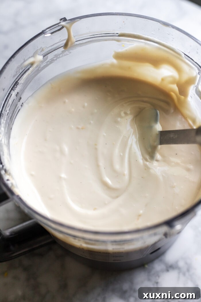 Smooth and creamy vegan cheesecake batter in a food processor.