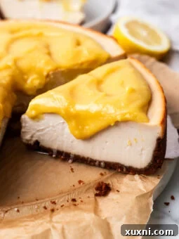Sliced lemon cheesecake with lemon curd on marble plate
