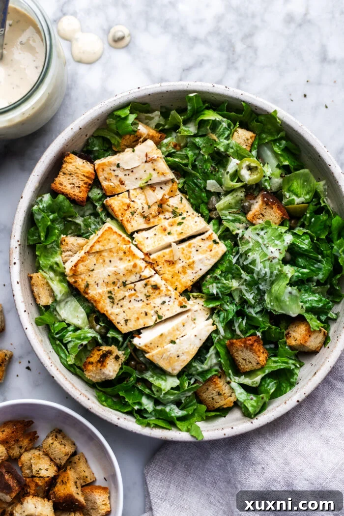 Super Simple Vegan Caesar with Zesty Lemon Tofu 2 Vegan Caesar salad in a bowl, showcasing its vibrant freshness and appealing texture.