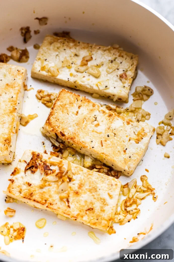 Super Simple Vegan Caesar with Zesty Lemon Tofu 5 Perfectly pan-seared lemon pepper tofu cutlets, ready to be added to the salad.