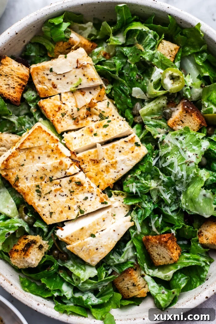 Super Simple Vegan Caesar with Zesty Lemon Tofu 9 Extreme close-up of a vegan Caesar salad, emphasizing the fresh ingredients and the creamy texture of the dressing.