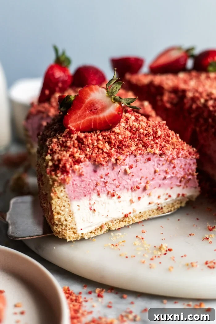 slice of strawberry crunch cheesecake on marble