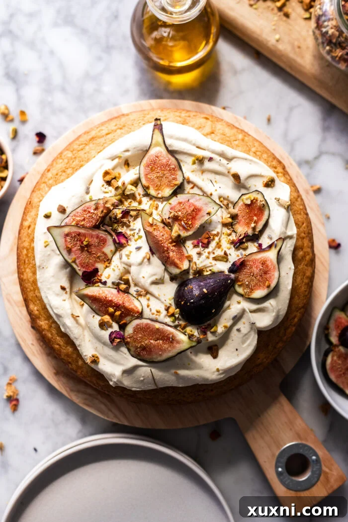 A beautiful vegan olive oil cake on a white plate, ready for its creamy topping.