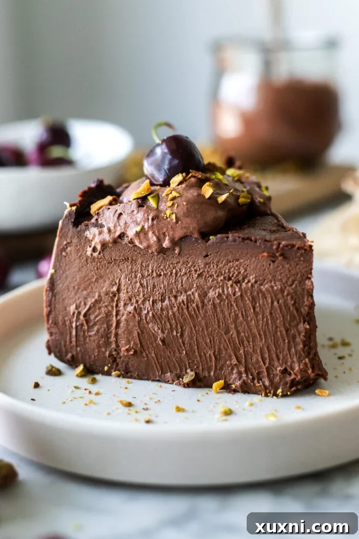 Luxuriously Creamy Vegan Chocolate Basque Cheesecake 2 A perfectly sliced vegan chocolate burnt Basque cheesecake, showcasing its creamy interior and distinct 'burnt' top layer.