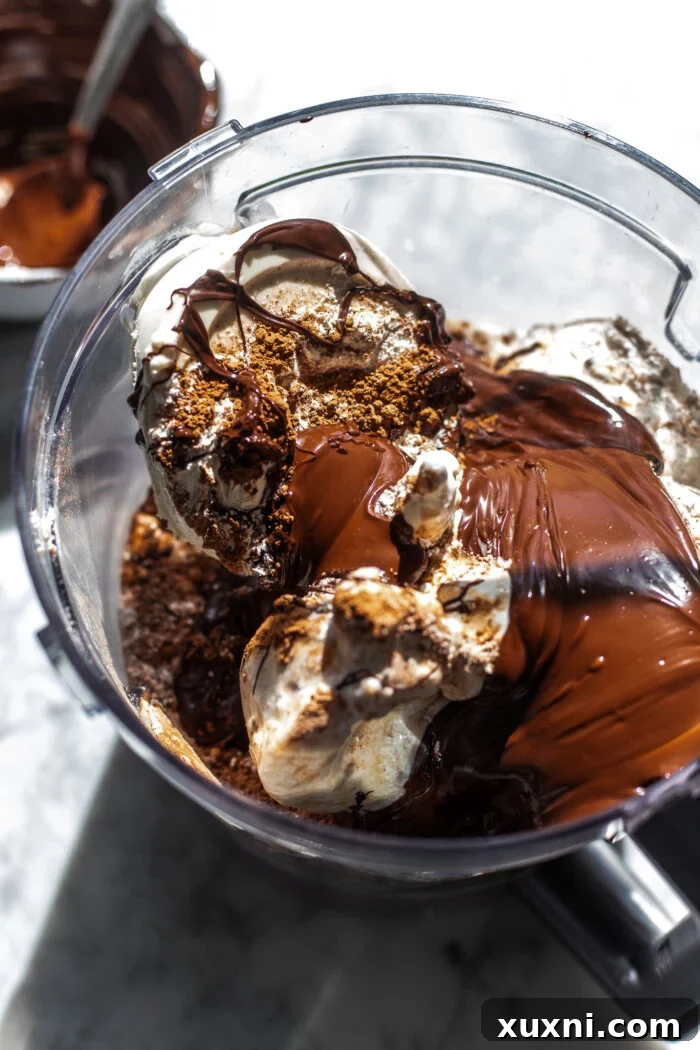 Luxuriously Creamy Vegan Chocolate Basque Cheesecake 5 All the vegan chocolate Basque cheesecake ingredients in a food processor, ready to be blended.