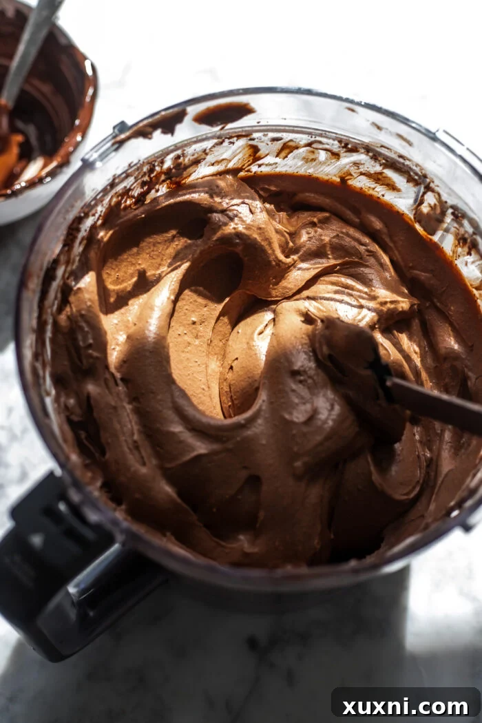 Luxuriously Creamy Vegan Chocolate Basque Cheesecake 6 Smooth and creamy blended vegan chocolate Basque cheesecake batter in a food processor bowl.