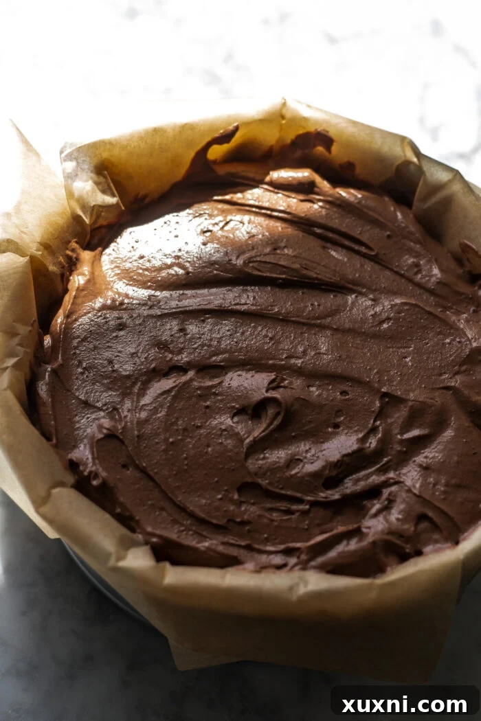 Luxuriously Creamy Vegan Chocolate Basque Cheesecake 7 Unbaked vegan chocolate Basque cheesecake batter perfectly poured into a parchment-lined springform pan.