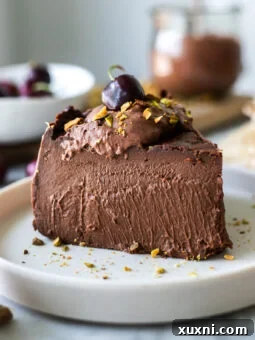 A sliced vegan chocolate burnt Basque cheesecake, revealing its creamy texture and rich chocolate color.