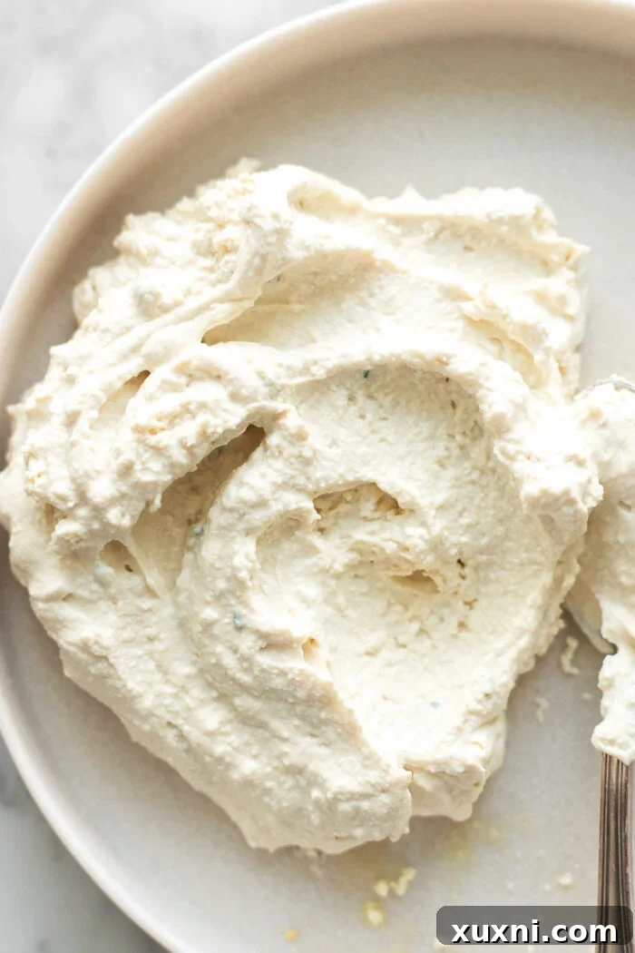 Close-up of fluffy whipped vegan ricotta on a plate.