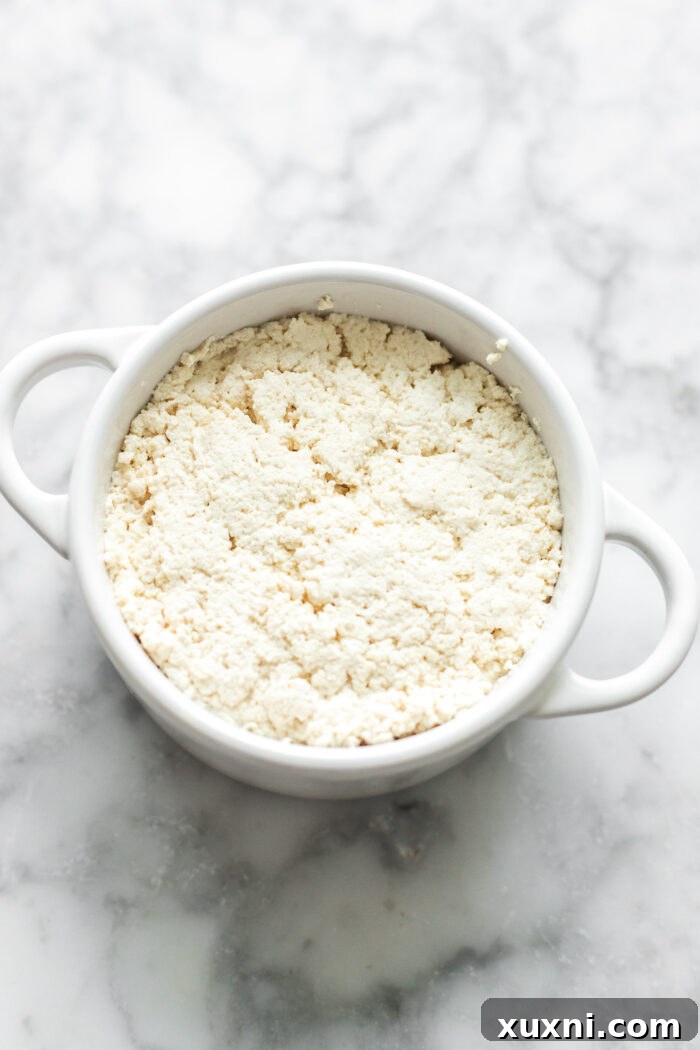 Shaping the vegan ricotta into a ramekin for chilling.