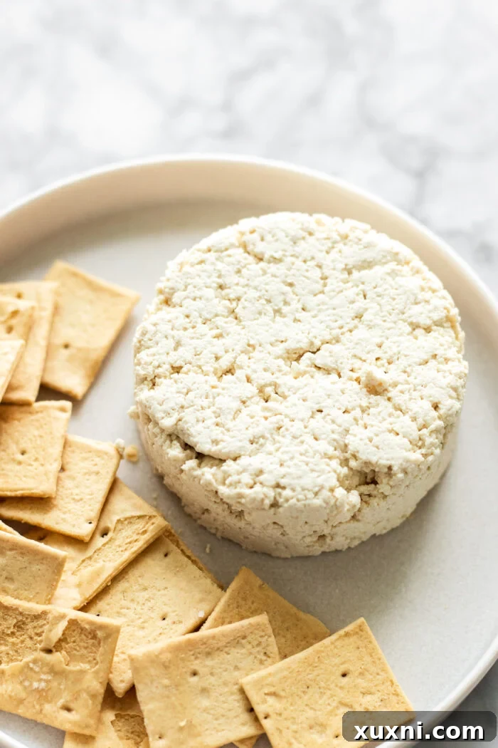 Chilled vegan ricotta flipped onto a plate, ready for serving.