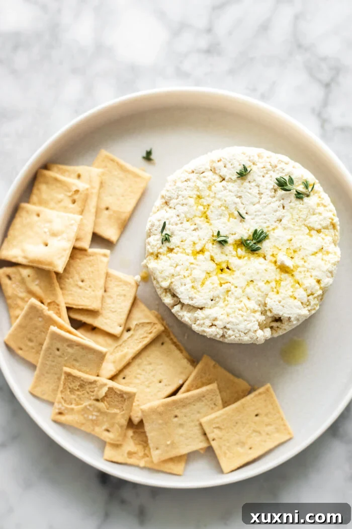 Vegan ricotta served with crackers and a drizzle of olive oil.
