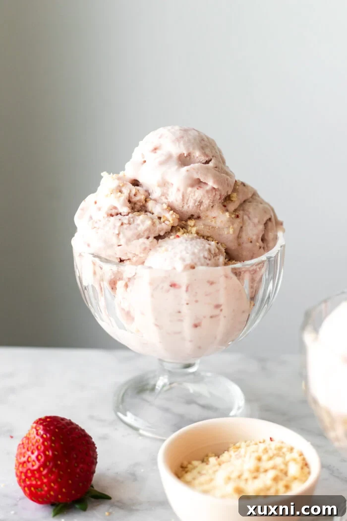 A large bowl filled with abundant scoops of creamy vegan strawberry ice cream