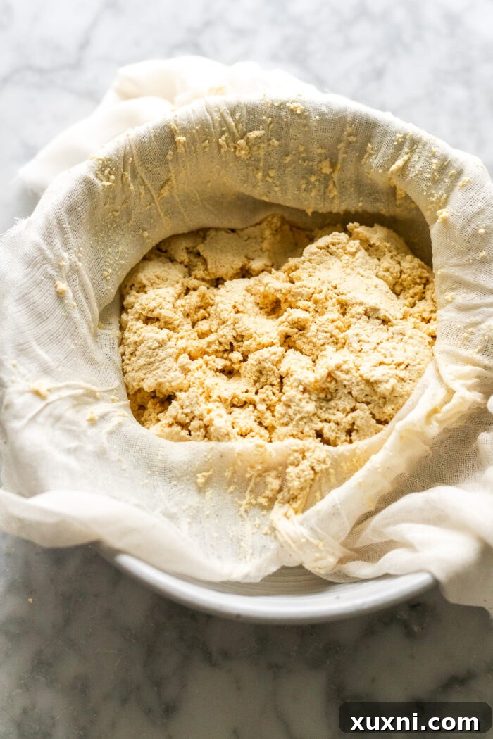 Mind-Blowing Vegan Cannoli Cake 5 ricotta being formed in a cheesecloth