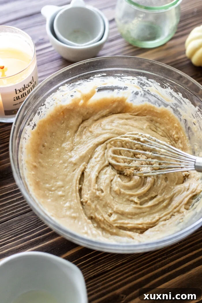 Smooth, spiced apple cider donut hole batter in a mixing bowl.