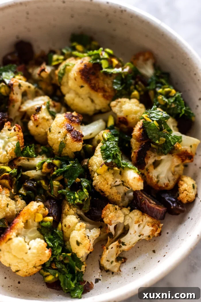 close up of roasted garlic cauliflower florets garnished with fresh gremolata