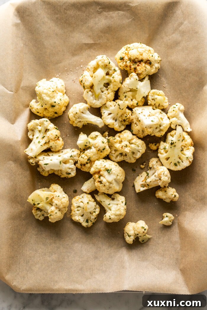 raw cauliflower florets arranged on a baking sheet before roasting