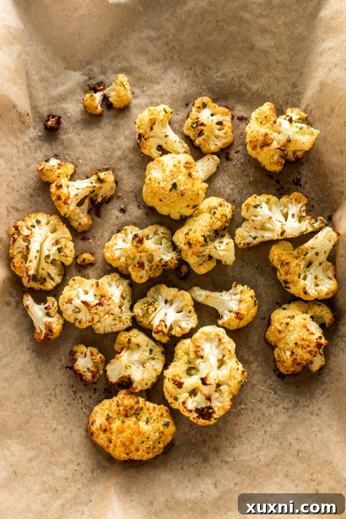 golden-brown roasted cauliflower florets on a baking sheet after roasting