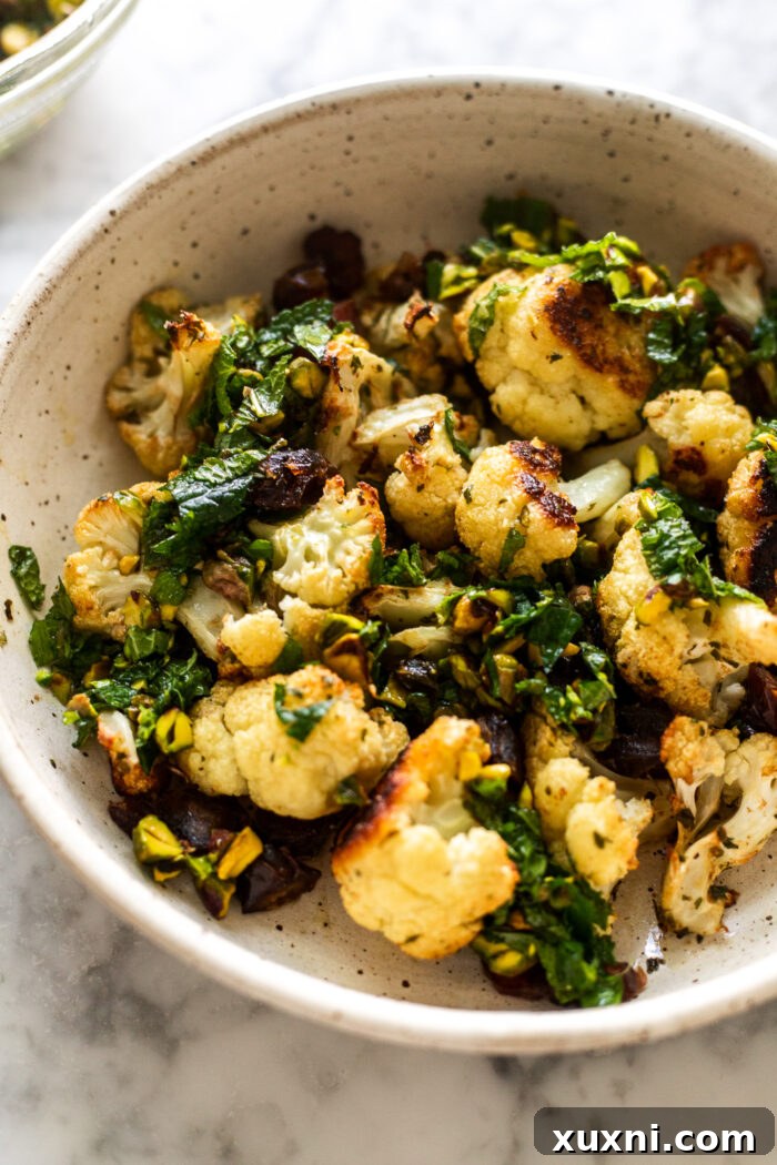 Roasted Garlic Cauliflower with Pistachio Mint Gremolata served in a rustic bowl
