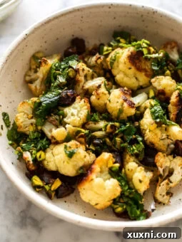 Roasted Garlic Cauliflower with Pistachio Mint Gremolata in a bowl, ready to be served.