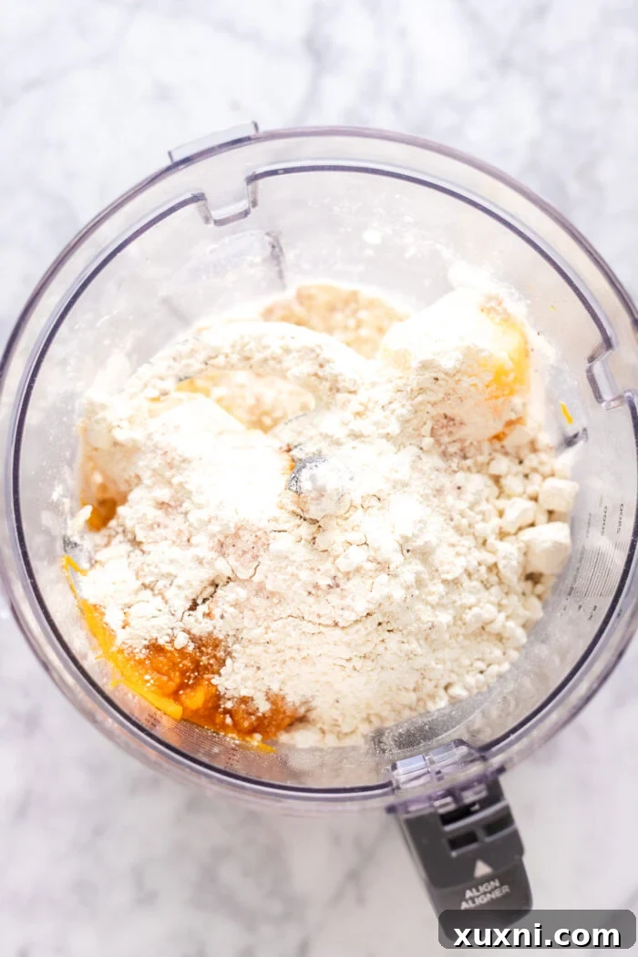 Ingredients for pumpkin gnocchi (pumpkin puree, flour, and cooked potatoes) arranged before blending.