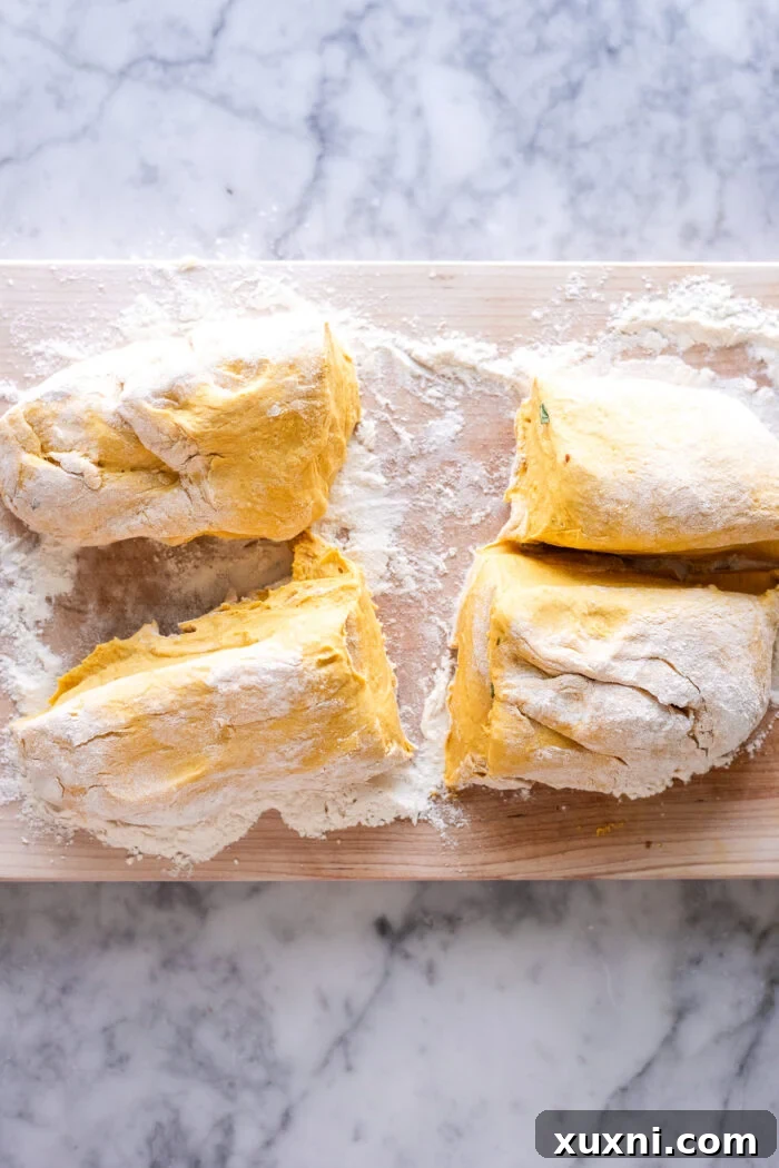 Sliced pieces of pumpkin gnocchi dough, uniformly cut and ready for boiling.