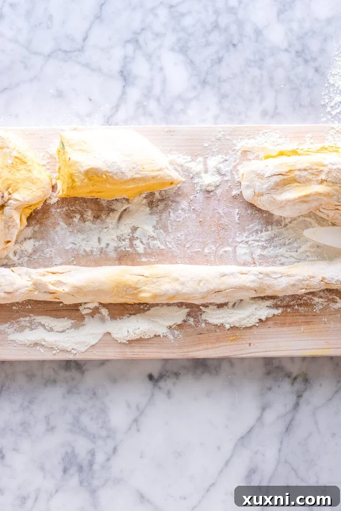 Uncooked pumpkin gnocchi dough, rolled and ready to be cut into individual dumplings.