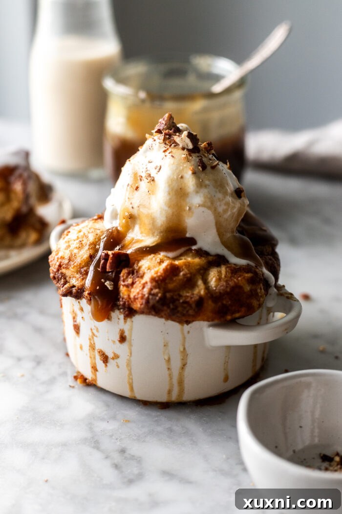 A small batch sticky toffee monkey bread still in its individual ramekin, showcasing its golden-brown top and rich sauce
