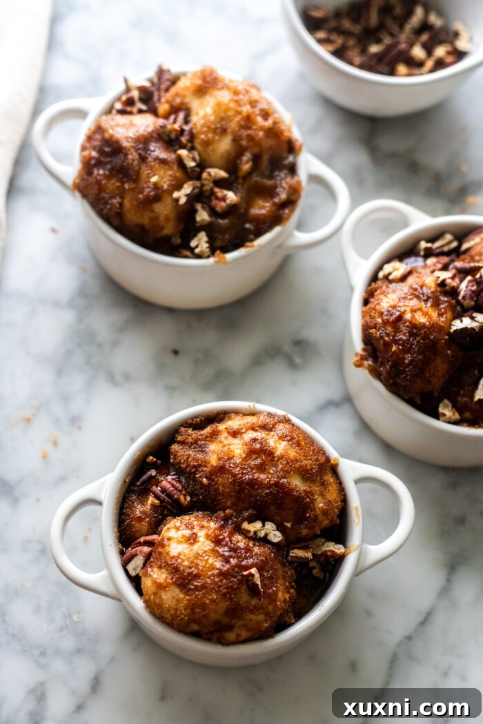 Monkey bread dough balls in a ramekin, covered with plastic wrap, preparing for overnight proofing