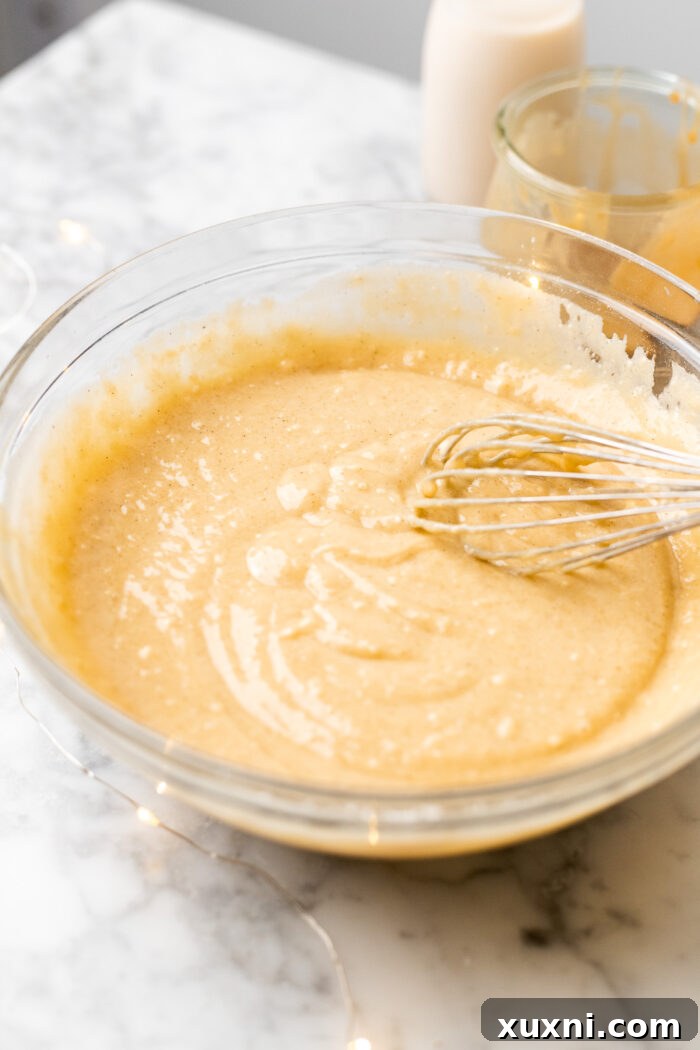 A bowl of light, creamy vanilla cupcake batter, ready to be baked into delicious vegan cupcakes.