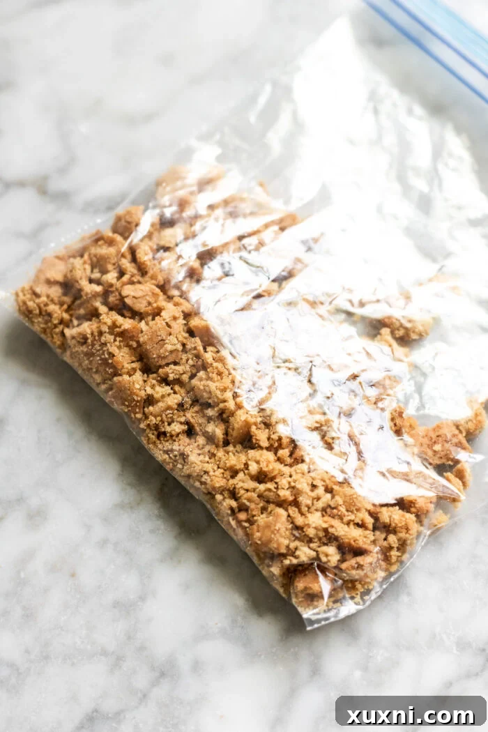 Crushed vegan graham crackers in a bag, ready for baking.