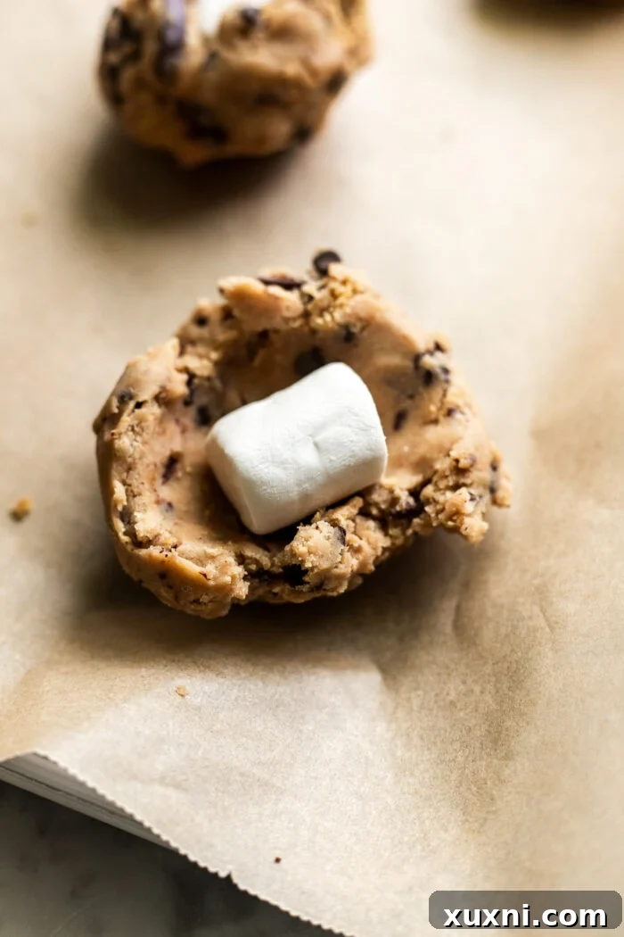 Stuffing the vegan cookie dough with a marshmallow center.