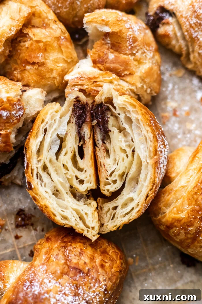 A perfectly sliced vegan croissant revealing its intricate, flaky layers.