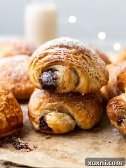 Stacked vegan pain au chocolat, showcasing their flaky layers and golden crust.