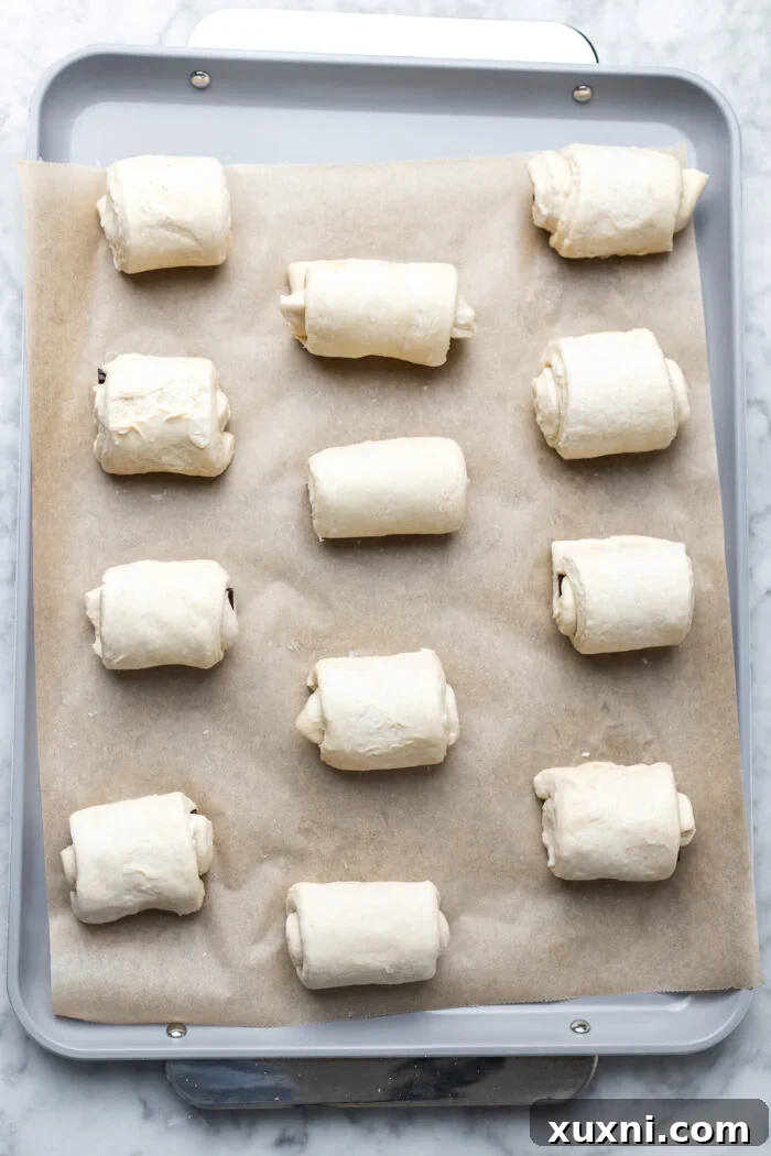 Unbaked vegan pain au chocolat, visibly risen and ready for the oven, showcasing the proofing stage.