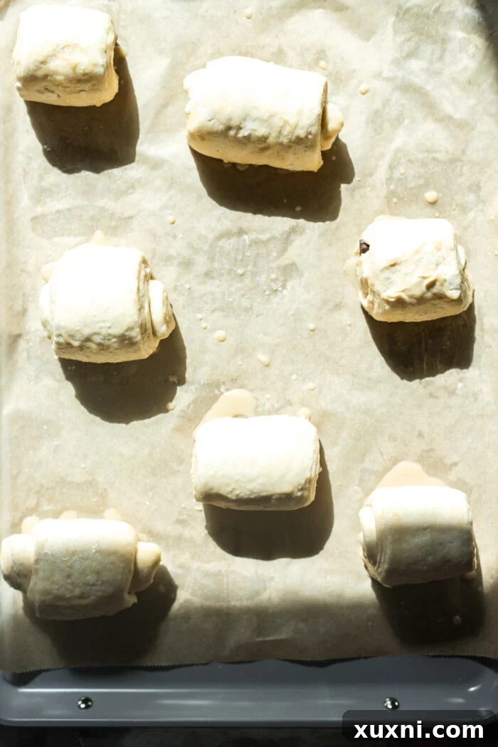 Proofed vegan pain au chocolat, significantly expanded and ready to be brushed and baked.