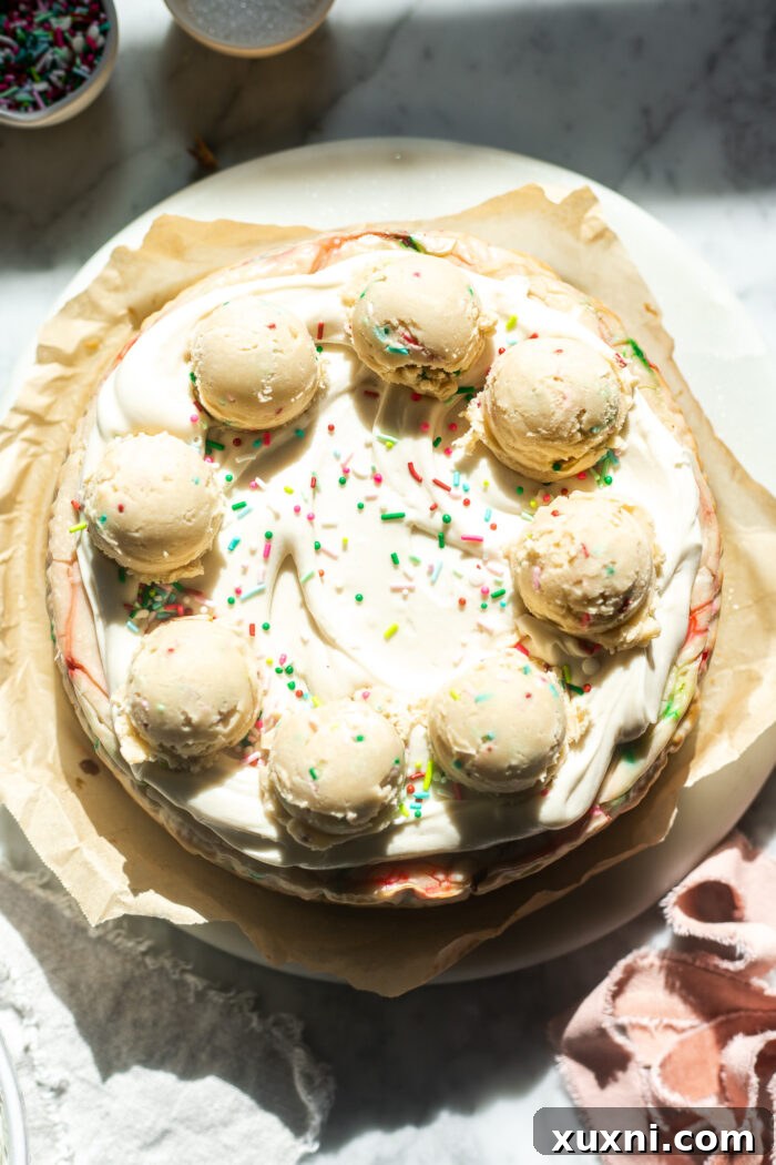Final image of a decorated vegan sugar cookie dough cheesecake, sliced and ready to serve.