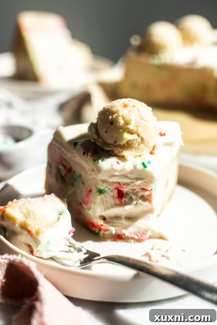 A close-up of a gluten-free vegan sugar cookie dough cheesecake slice with a bite, highlighting its texture.