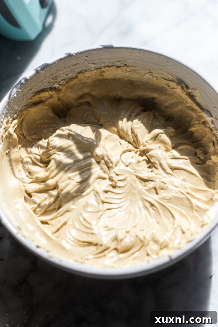 Adding espresso powder and vanilla bean paste to mascarpone cream