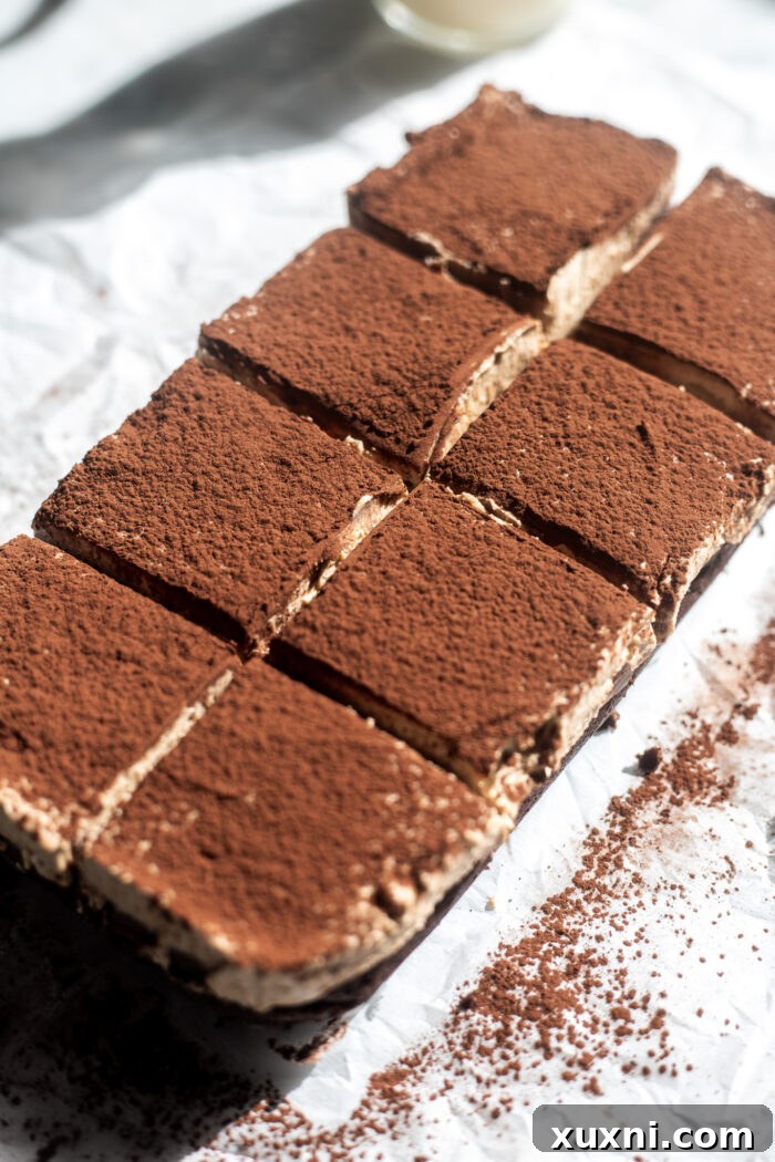 Dusting cocoa powder on tiramisu brownies