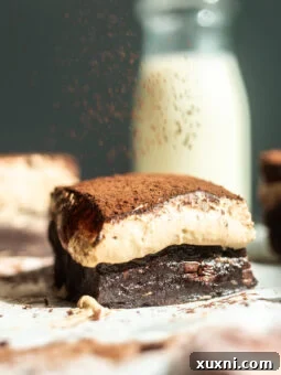 dusting cocoa on tiramisu brownie