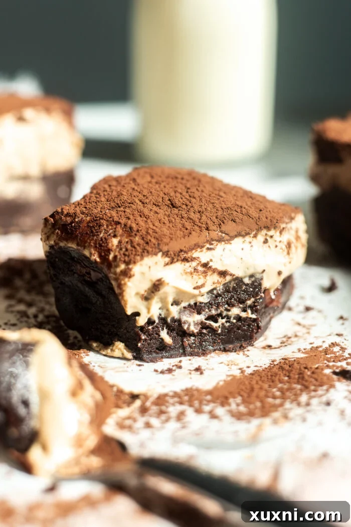 bitten vegan tiramisu brownie on parchment paper