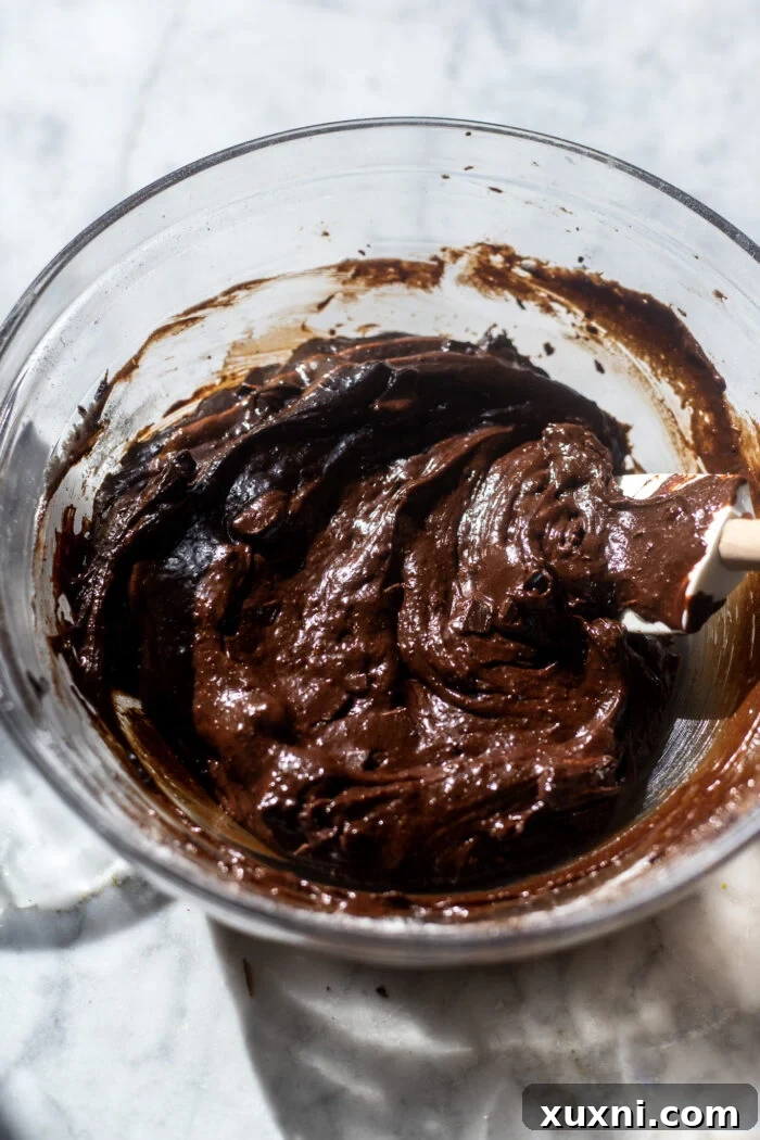 Folding flour and chocolate chips into brownie batter