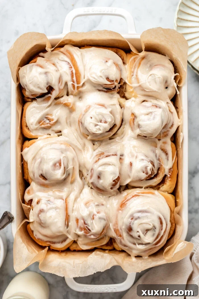 Warm vegan cinnamon rolls generously topped with creamy white icing.