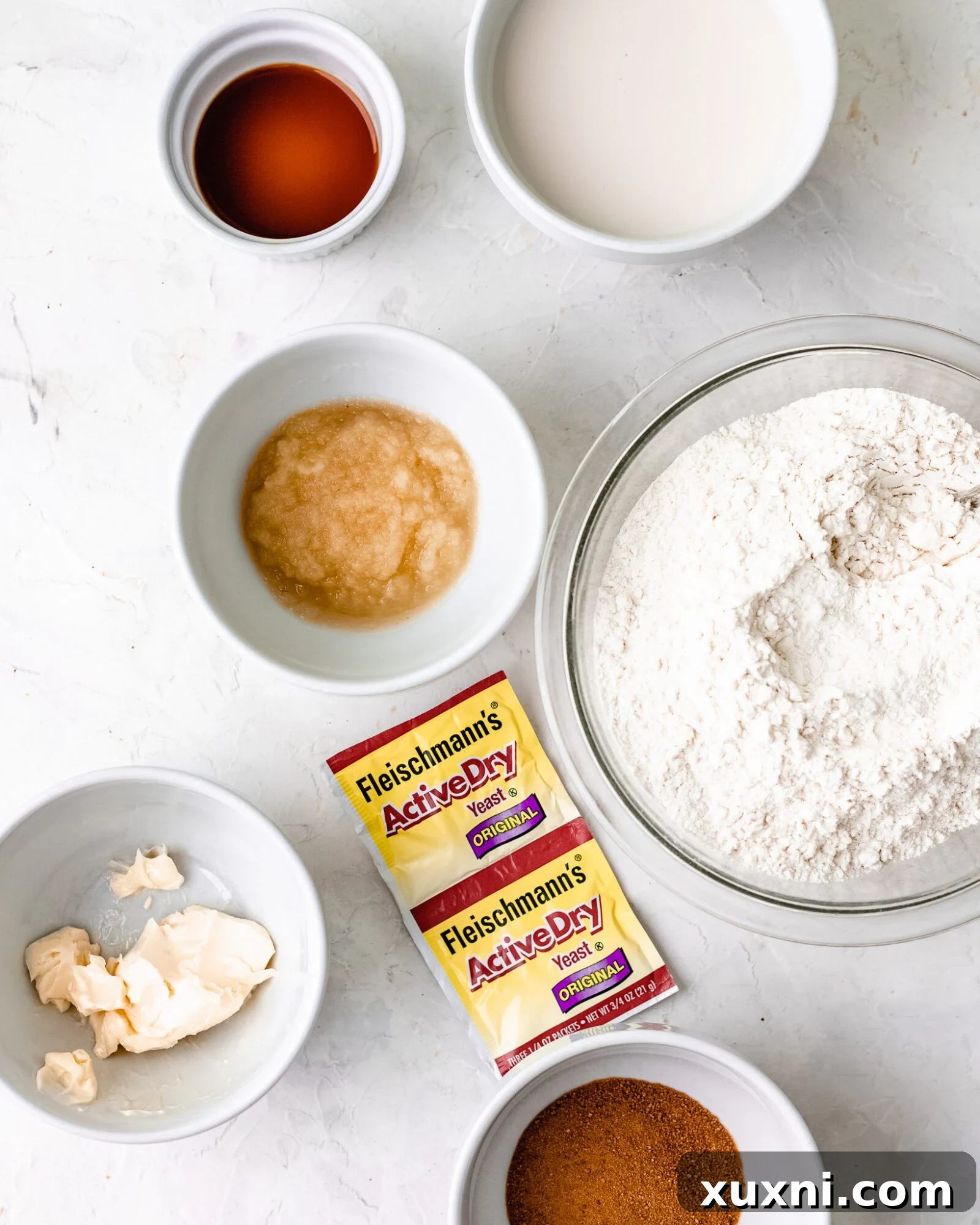 A flat lay image displaying all the simple, wholesome ingredients for making vegan cinnamon rolls.