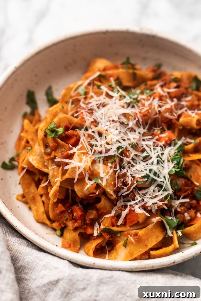 The Easiest 8-Ingredient Plant-Based Bolognese 8 A beautifully plated bowl of vegan lentil bolognese garnished with fresh basil, ready for serving.