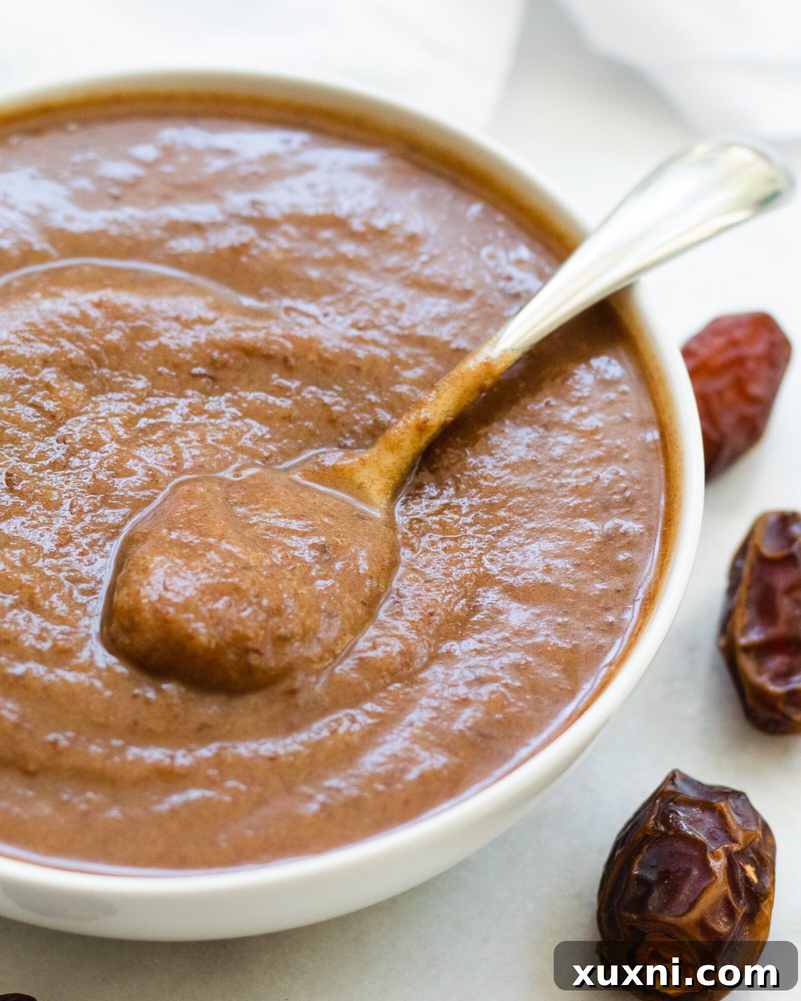 close up of bowl of date caramel sauce with coconut milk