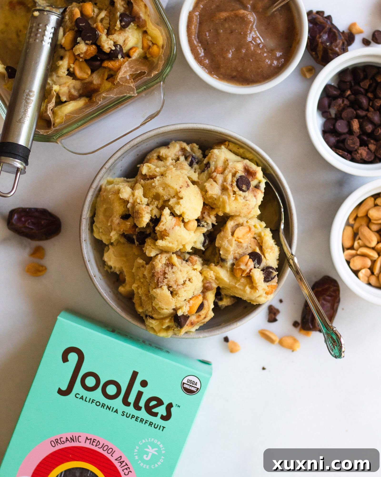 bowl of vegan snickers ice cream with dates and ice cream scoop